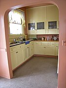 Modernist built-in cabinets, white, reaching all the way up to the ceiling