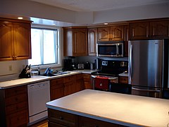 Dark stain-grade wood (oak), with crown-molding