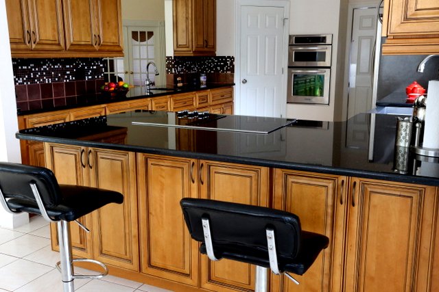 Black Galaxy granite contrasted with honey glazed cabinets