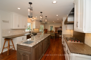 Blue Flower granite island with Cygnus granite perimeter counters in illinois home