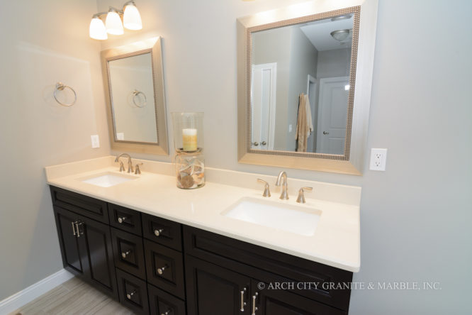 Combination of light quartz counters with dark cabinets for a double bowl vanity top in the missouri area