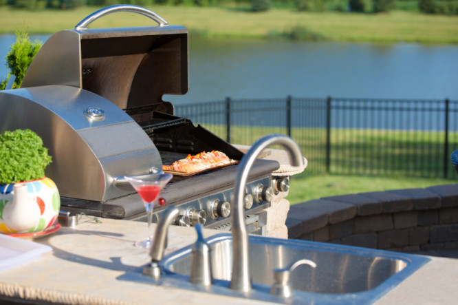 Cooking Salmon on the cedar plank in the barbecue at the outdoor kitchen