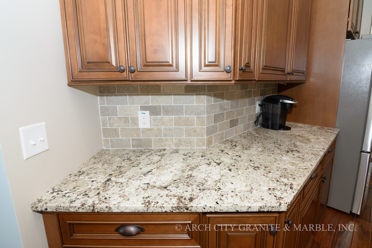 White granite coffee bar countertop with travertine subway tile in st. louis