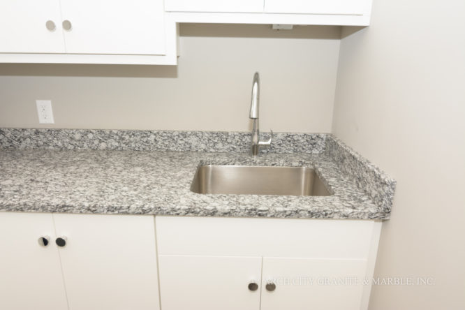 White Mist granite installed with 4” back splashes for a laundry room countertop in Illinois area