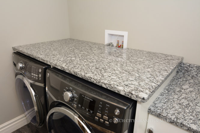 White Mist granite installed to complement the grey and white washer, dryer in the laundry room in illinois