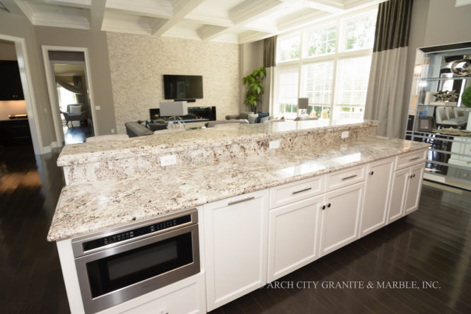 Two Tiered Island with White granite and same granite as a backsplash between upper and lower counters